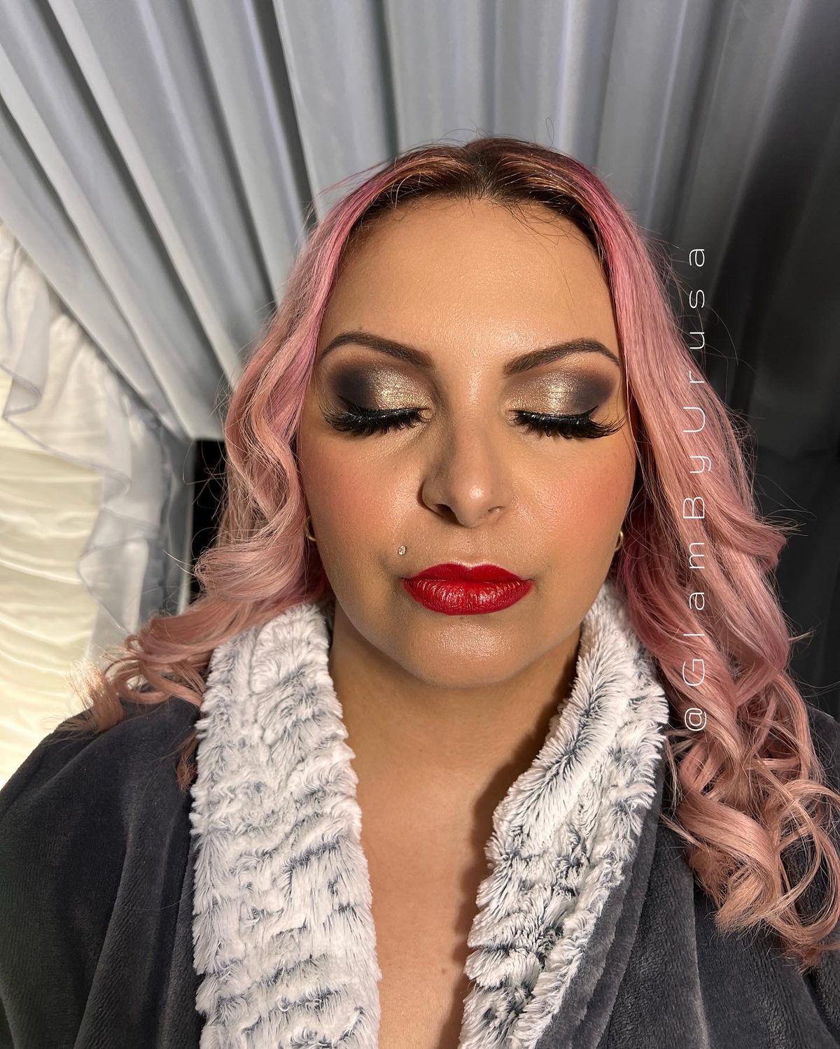 Full glam makeup with a bronze smokey eye, dramatic lashes and a bold red lip