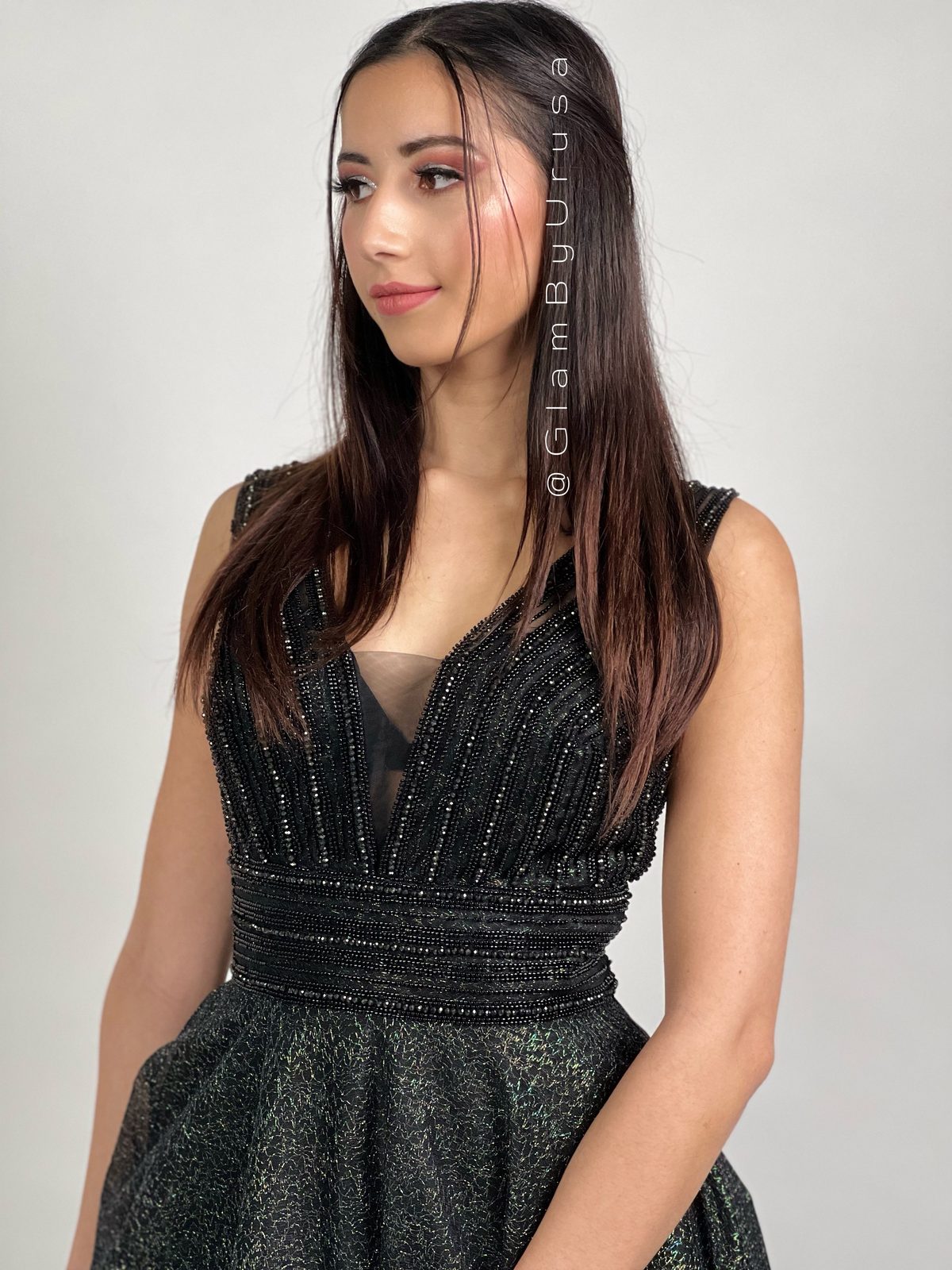 Sleek straight blowout with a centre part and soft glam makeup for a formal event