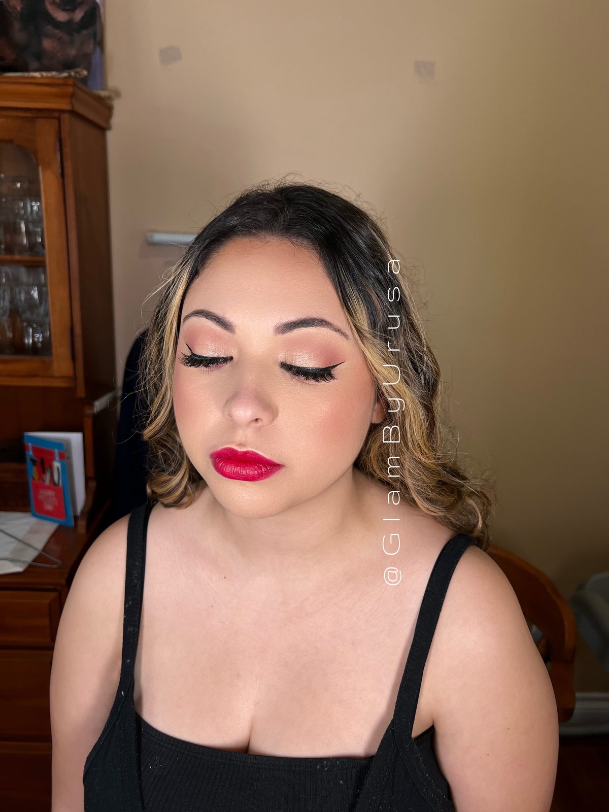 Classic glam makeup with a red lip, neutral shimmer eye and soft waves