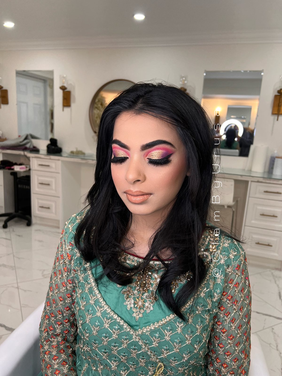 Semi-bridal party makeup with a bold pink smokey eye, sculpted cheeks and voluminous curls