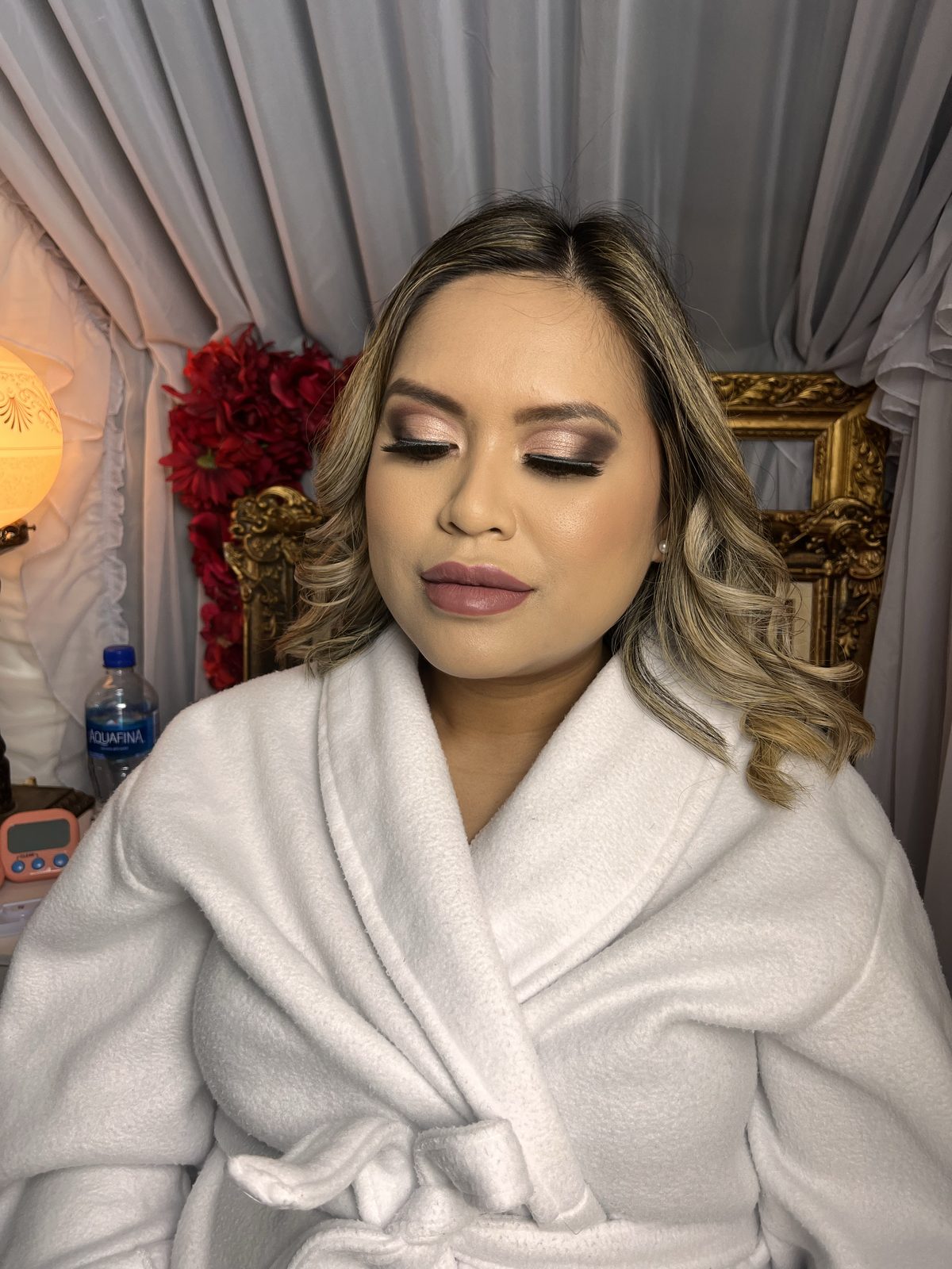 Soft glam makeup with blended neutral eyes, a nude lip and loose curled hair